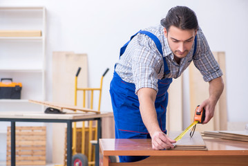 Young male carpenter working indoors 