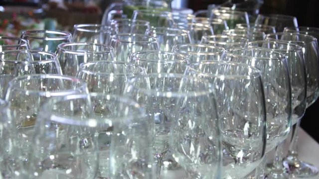 Crystal clear glass goblets shine on the banquet table