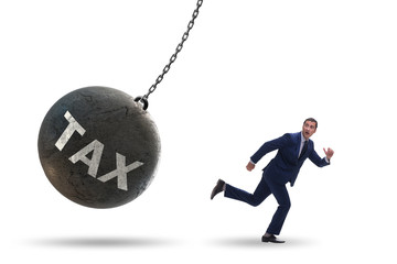 Businessman running away from high taxes
