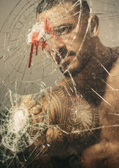 aggression. crush test. theft. emotional discharge. bullet hole in glass. broken glass because of hit. macho man behind crushed glass. sexy hispanic man broken mirror. anger aggression. destruction