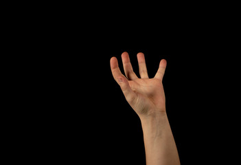 Fototapeta premium The hand of a young man on a black background