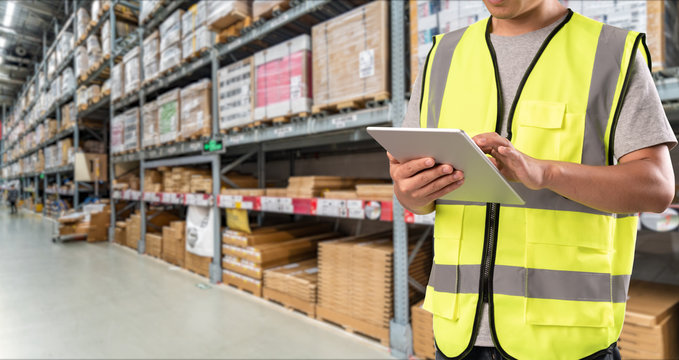 Worker Hand Holding Pad For Check Order Pick Time In Smart Factory Warehouse