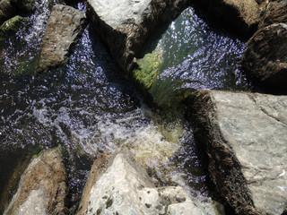 Rapid flow of water flows through large rocks