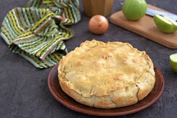 A hearty pie with potatoes, apples and cheese on shortbread dough. Swiss cuisine. Savory pies.