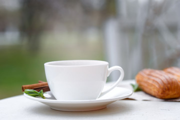 Fragrant coffee with eclairs in the summer cafe.