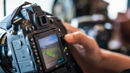 Photographer Setting A Digital Camera