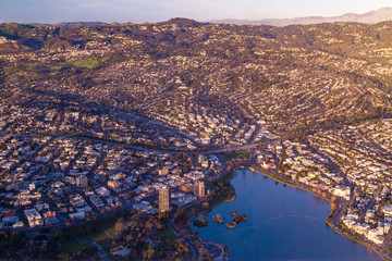 Aerial view of hilly city with lake at sunset - Lake Merritt, Oakland, California
