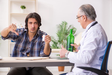 Young male alcoholic visiting old doctor  