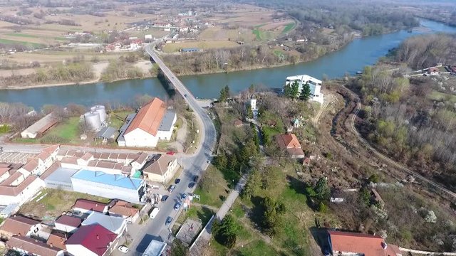 Small modern agricultural Serbian village Varvarin in central Serbia aerial view with houses fields and west Morava river