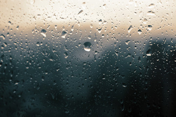 Big raindrops on window glass in stormy weather