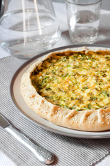 Tart with eggs and green onions on a plate