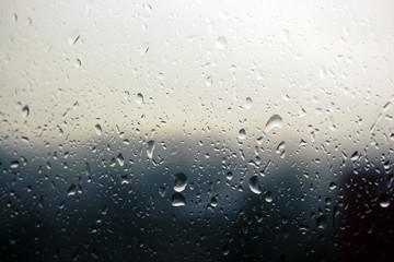 Big raindrops on window glass in stormy weather