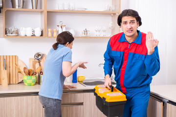Young male repairman repairing tap 