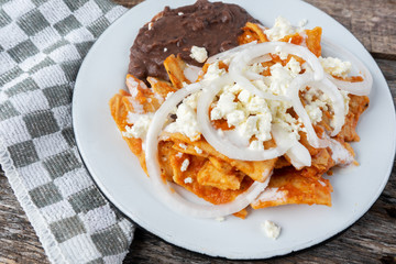 Mexican red chilaquiles with beans and cheese