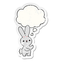 cute cartoon rabbit and thought bubble as a distressed worn sticker