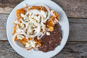 Mexican red chilaquiles with beans and cheese