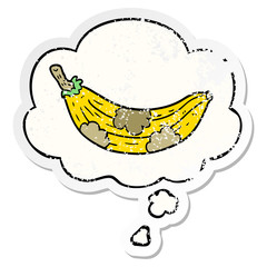 cartoon old banana and thought bubble as a distressed worn sticker