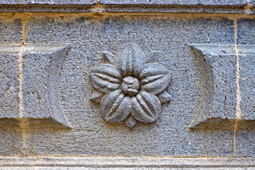 A floral sandstone relief decoration on an old building.