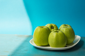 green apples on wooden table
