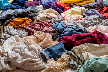 pile of used clothes on a light background. Second hand for recycling - 275994151