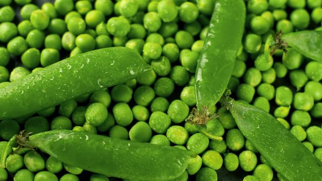 Fresh green pease and shells. Close up 4k footage of food. Top view.