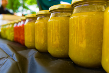 jars filled with madam jeanette chilli sold on the street fair