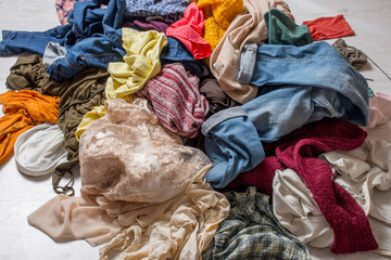 pile of used clothes on a light background. Second hand for recycling