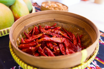 wooden bowl with red peppers on the street fair