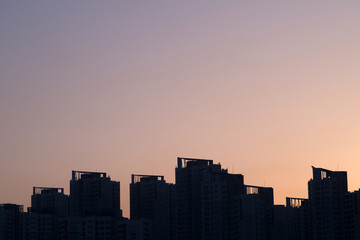 Fototapeta na wymiar City silhouette against the sky on a sunset.