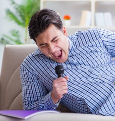 Funny man singing songs in karaoke at home