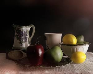 Obraz na płótnie Canvas still life photo of fruit with a creamer and cup and fruit in a matching bowl with shadows and texture