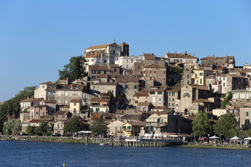Fototapeta premium Anguillara Sabazia, Italy - 30 June 2019: The town and Lake Bracciano with tourists