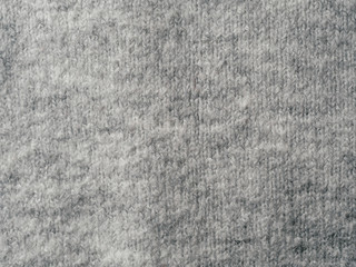 Gray sweater fabric texture. Clothes sweater background with folds