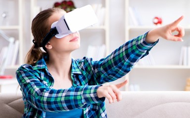 Female student sitting on the sofa with virtual glasses