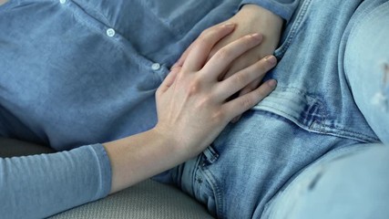 Unhealthy young woman with stomachache