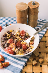 Salad of red beans, yellow corn, crackers. Picnic basket and a beautiful blue towel.