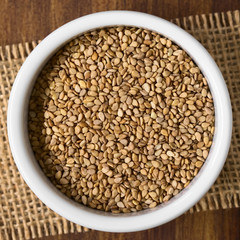 Roasted sesame seeds in small bowl, photographed overhead with natural light (Selective Focus, Focus on the seeds on the top)