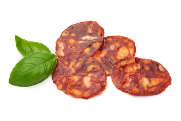 Spanish pork chorizo sausage slices, close-up, isolated on white background