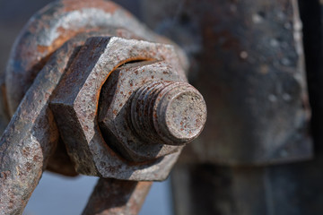 Rusty bolt with a nut in the mounting post