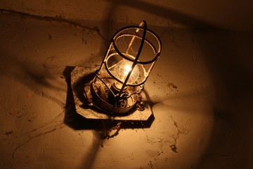 Old industrial lamp in an abandoned basement.