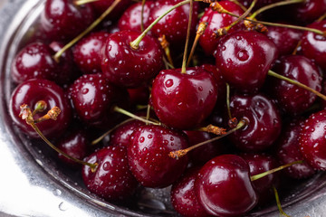 Fresh ripe black cherries in a metal bowl on a grey wooden background Close up - Image