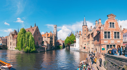 Panoramic city view with Belfry tower and famous canal in Bruges, Belgium. - obrazy, fototapety, plakaty
