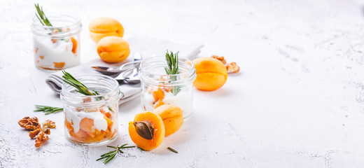 Natural yogurt with pieces of apricots and rosemary
