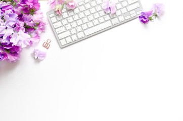 Flowers and keyboard, white space, flat lay