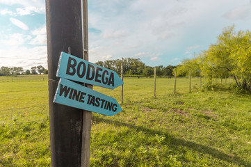 Signs pointing to bodega or wine tasting in Colonia del Sacramento