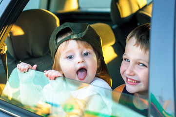 Happy family on a road trip in their car, rear passenger POV