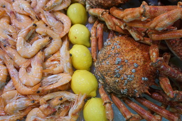 fresh shrimps and crabs wiht lemon on display at the market