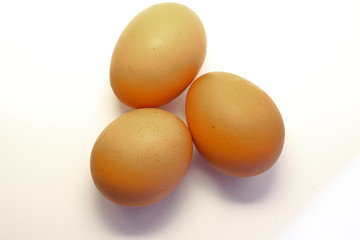 Closeup view of three eggs isolated on white background