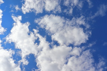 Blue sky background with clouds in summer.