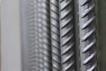 Fototapeta premium Closeup view on steel building armature in a row. Construction background image.